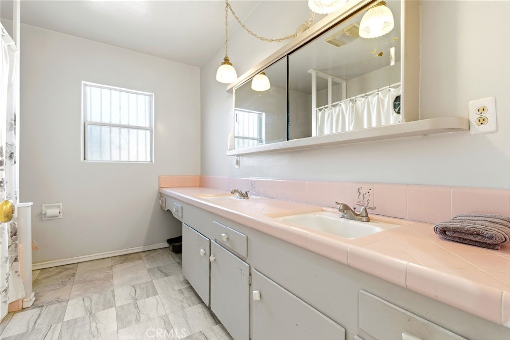 10731 Wright Road South Gate, CA 90280 - Photo 25 of 35 a bathroom with a sink and a mirror