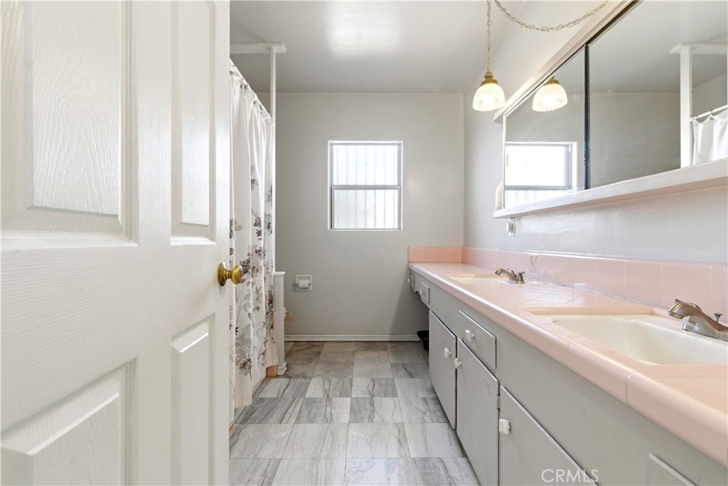 10731 Wright Road South Gate, CA 90280 - Photo 26 of 35 a bathroom with a sink and a mirror