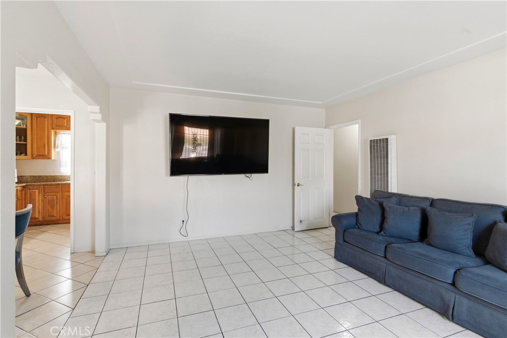 10731 Wright Road South Gate, CA 90280 - Photo 6 of 35 a living room with a couch and a flat screen tv