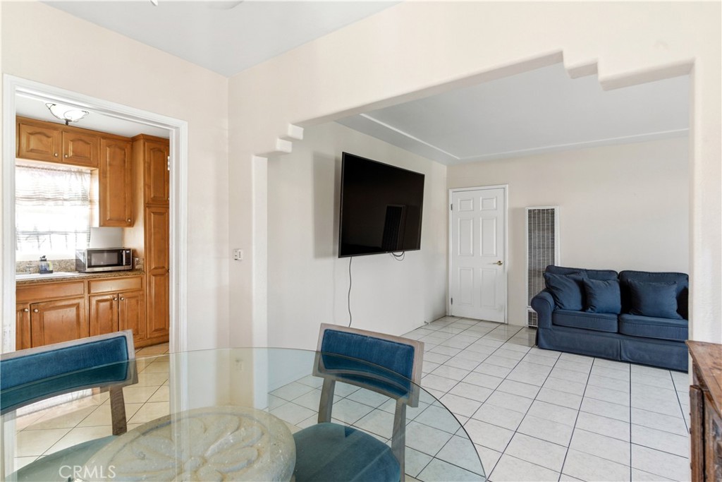 10731 Wright Road South Gate, CA 90280 - Photo 7 of 35 a living room with furniture and a flat screen tv