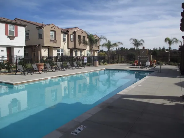 a front view of a house with swimming pool and porch