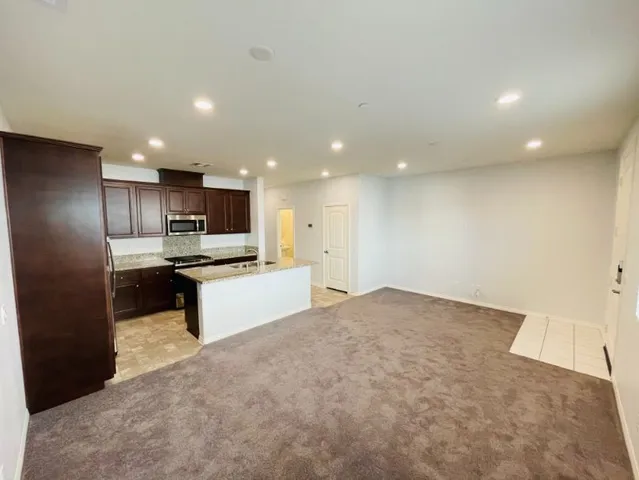 a kitchen with refrigerator cabinets and wooden floor