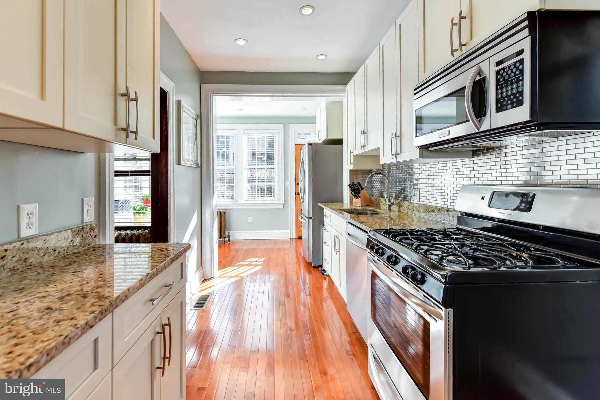 637 E Street Northeast Washington, DC 20002 - Photo 11 of 29 a kitchen with stainless steel appliances granite countertop a stove and a sink