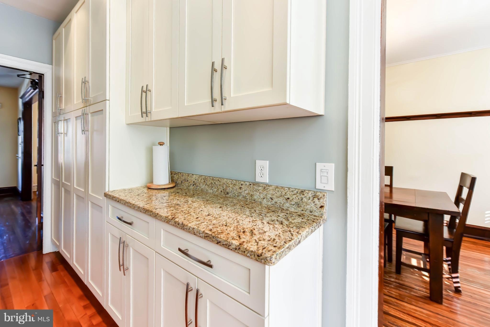 637 E Street Northeast Washington, DC 20002 - Photo 13 of 29 a kitchen with granite countertop white cabinets and refrigerator