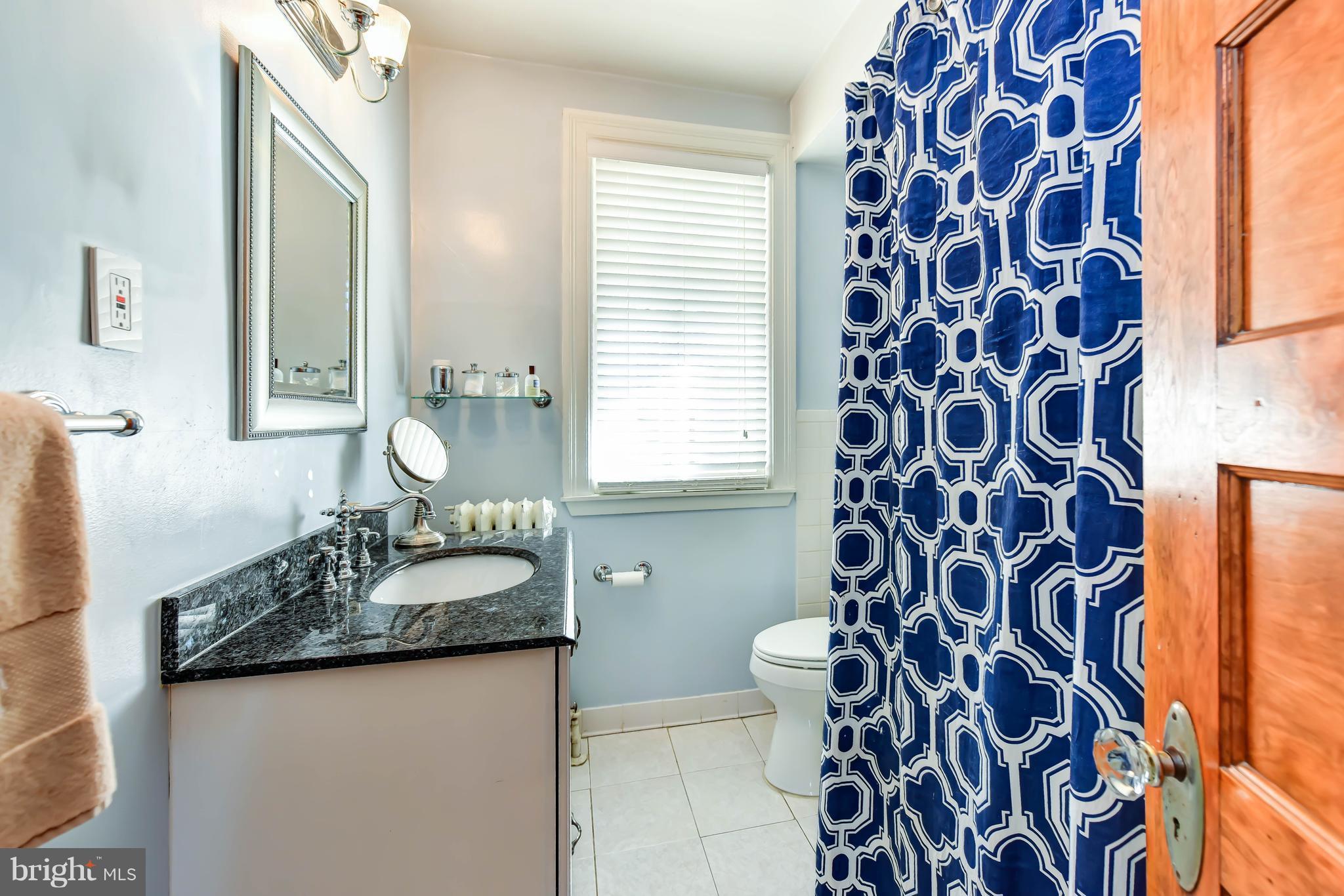 637 E Street Northeast Washington, DC 20002 - Photo 20 of 29 a bathroom with a granite countertop sink and a mirror