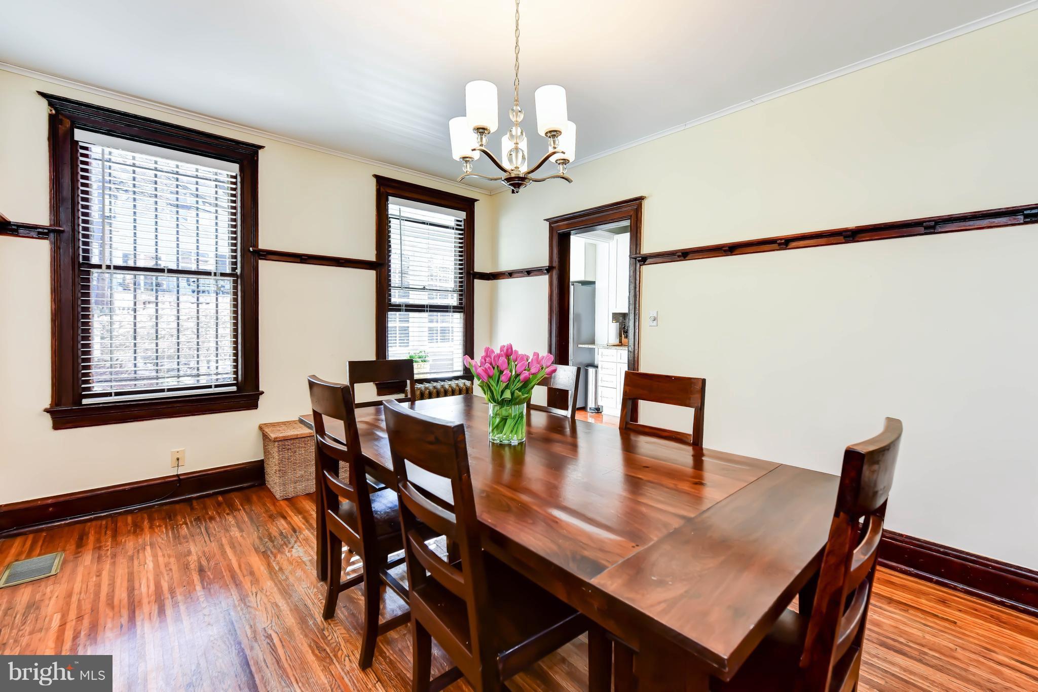 637 E Street Northeast Washington, DC 20002 - Photo 9 of 29 a dining room with furniture potted plants and wooden floor