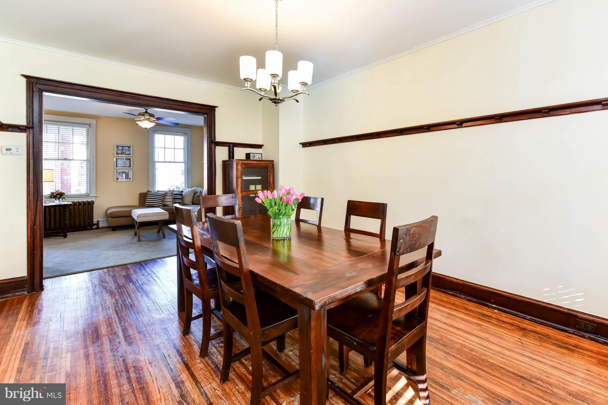 637 E Street Northeast Washington, DC 20002 - Photo 10 of 29 a view of a dining room with furniture a chandelier and wooden floor