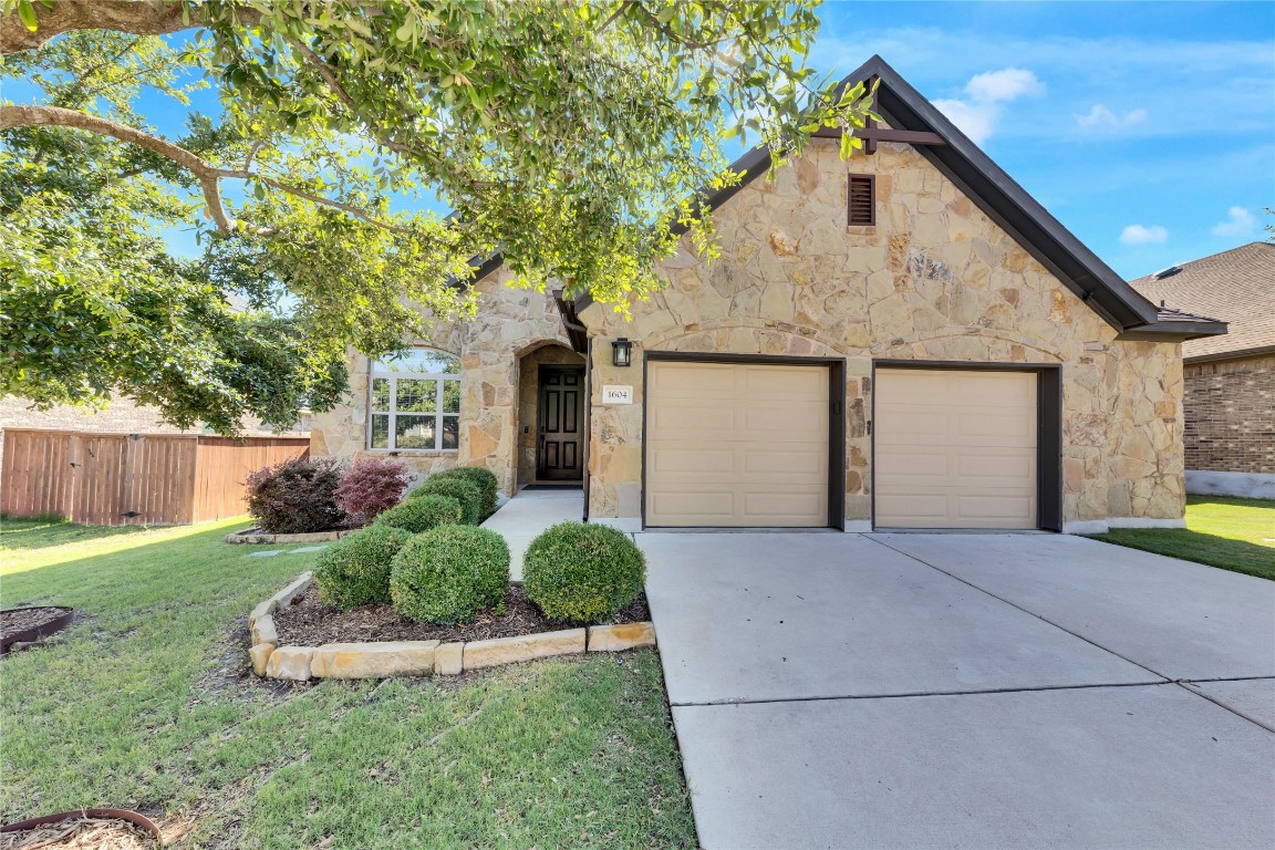 1604 Long Shadow Lane Georgetown, TX 78628 - Photo 1 of 1 a front view of a house with a yard and garage