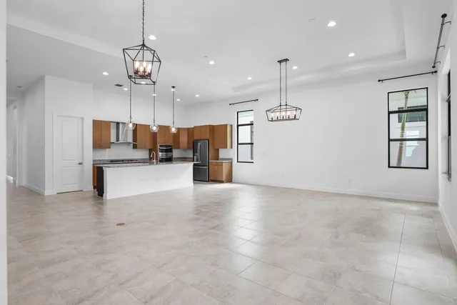 a view of a kitchen with a sink and chandelier