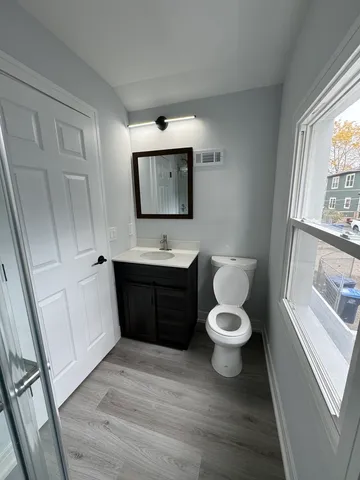 a bathroom with a toilet sink and mirror