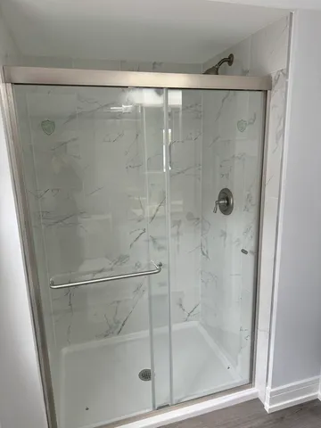 a bathroom with a glass shower door