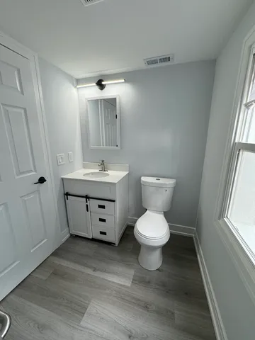 a bathroom with a toilet sink and a mirror