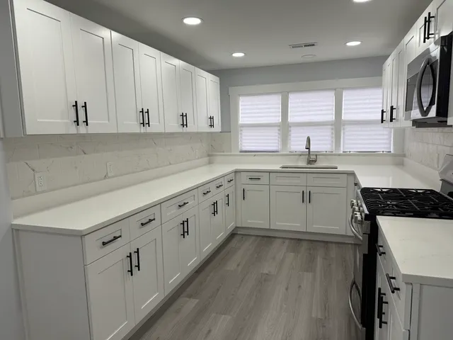 a kitchen with cabinets a sink and appliances