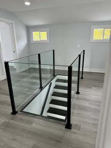 a view of entryway and hall with wooden floor
