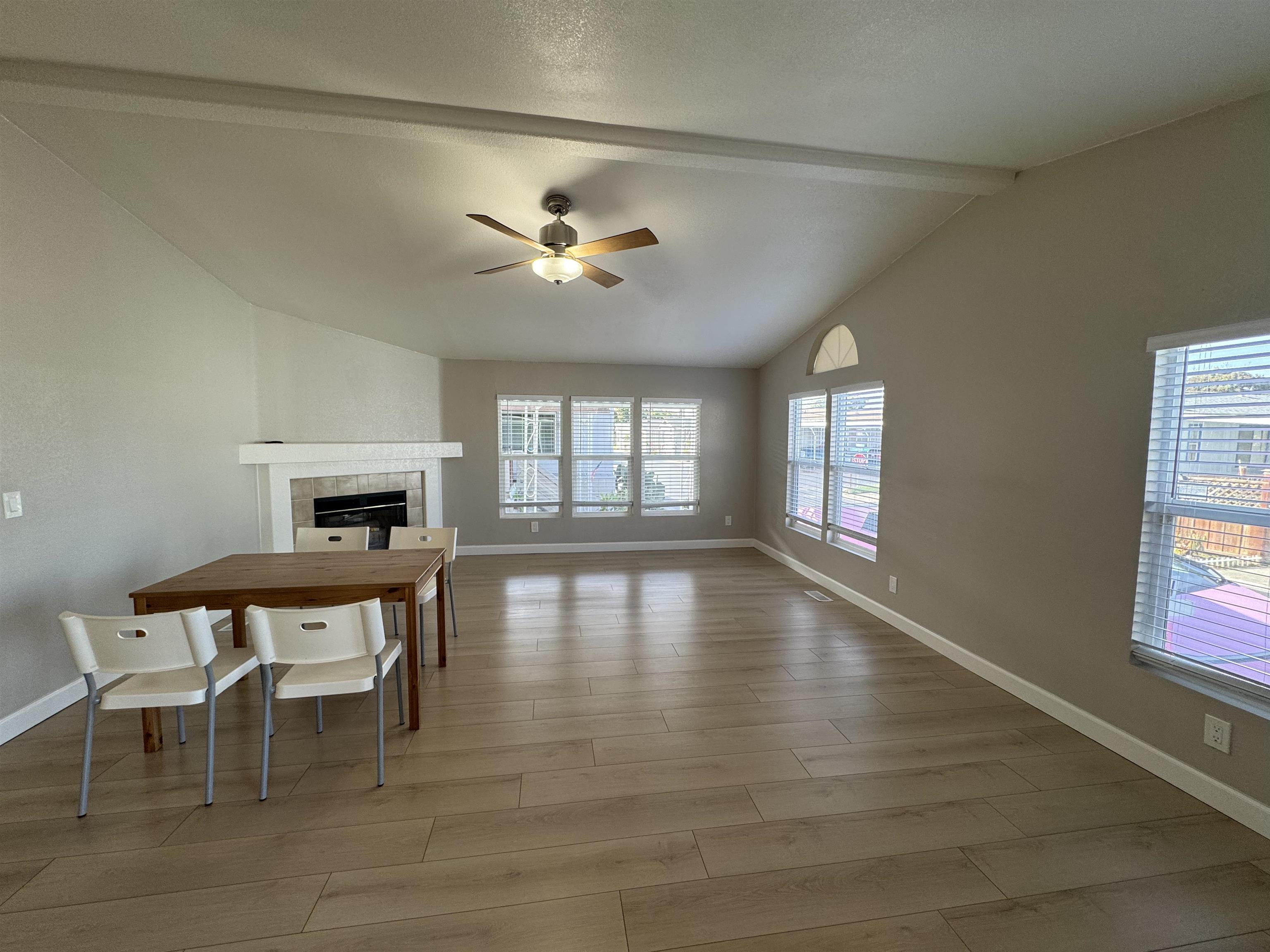 2151 Oakland Road, Unit 232 San Jose, CA 95131 - Photo 4 of 17 a view of a livingroom with furniture a fireplace a chandelier and wooden floor