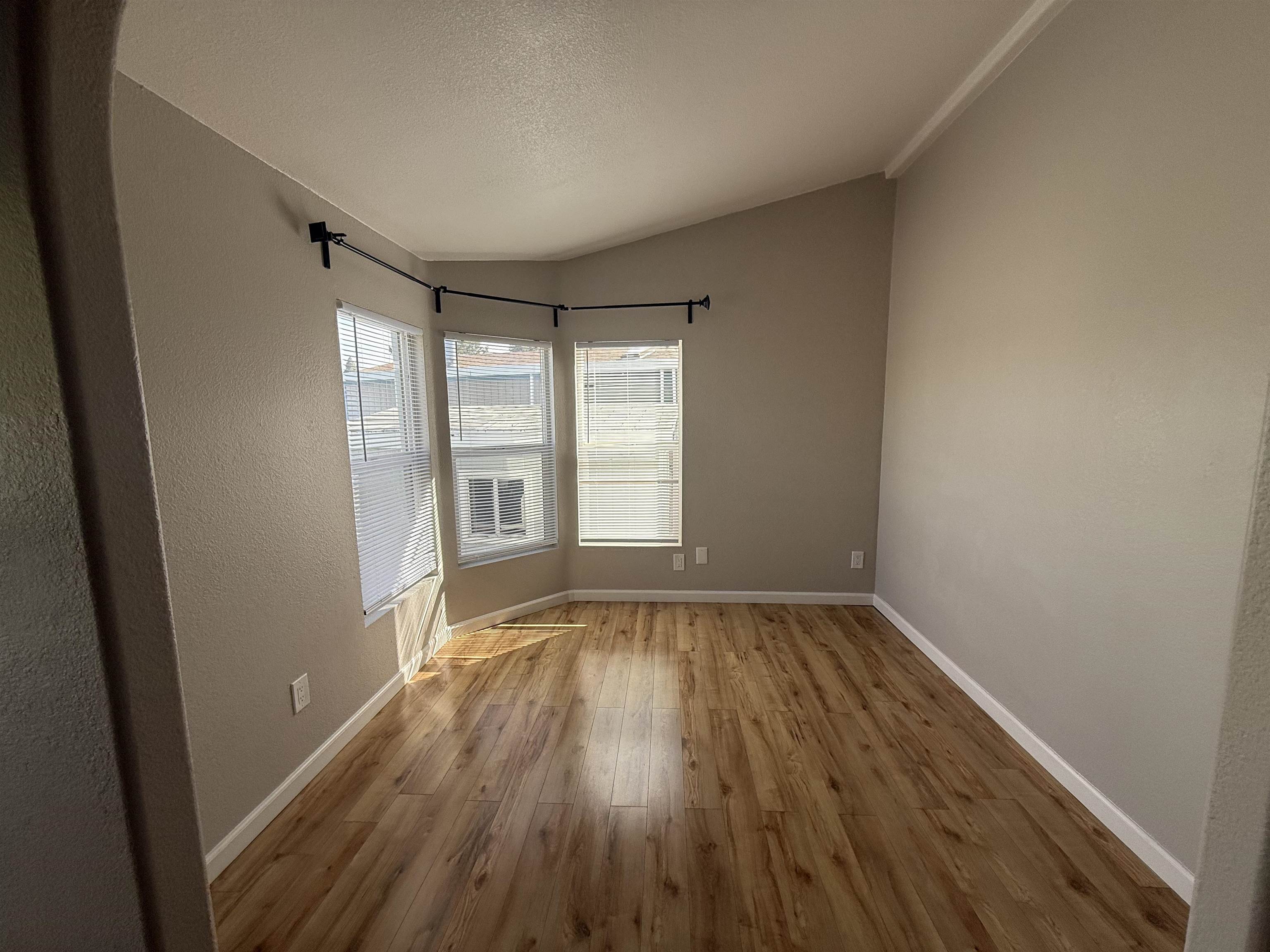2151 Oakland Road, Unit 232 San Jose, CA 95131 - Photo 9 of 17 a view of an empty room with wooden floor and a window