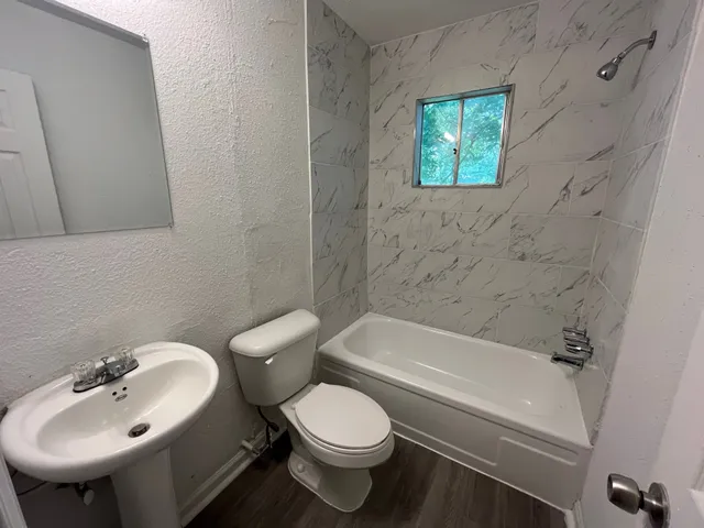 a bathroom with a sink toilet and bathtub