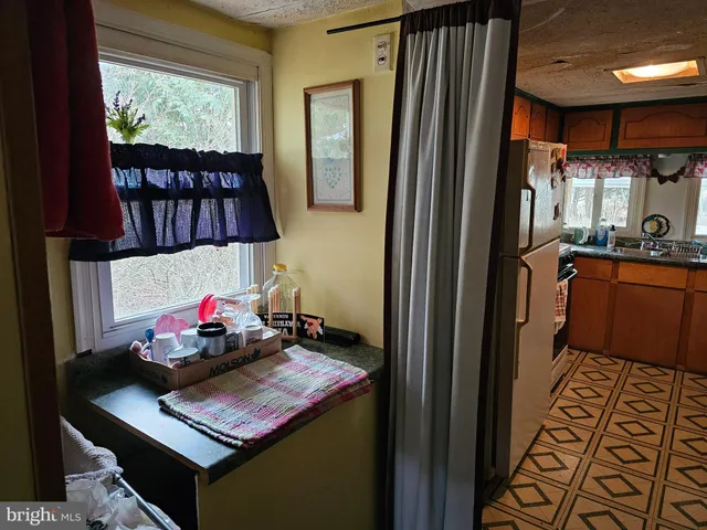 a kitchen with a refrigerator and a stove top oven