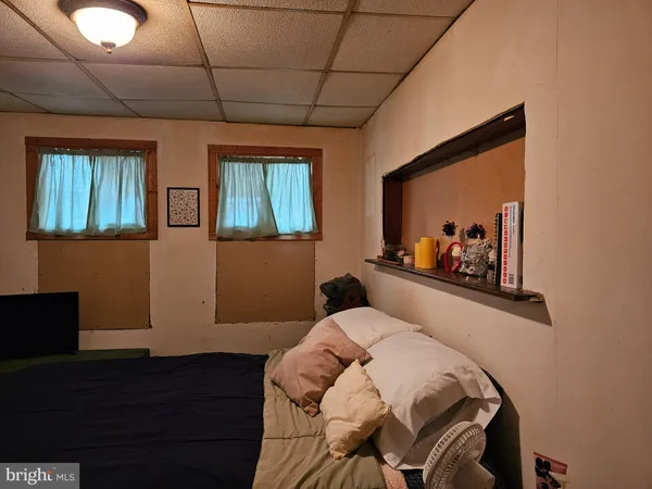 a bedroom with a bed and a painting on the wall