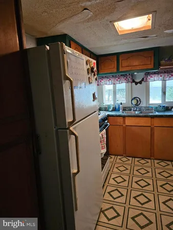 a kitchen with stainless steel appliances a refrigerator and a microwave