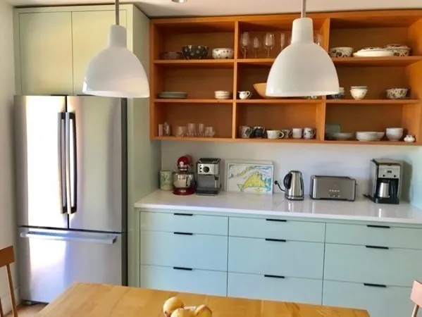 a kitchen with a refrigerator and cabinets