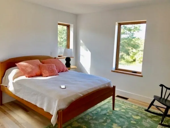 a bedroom with a bed and window