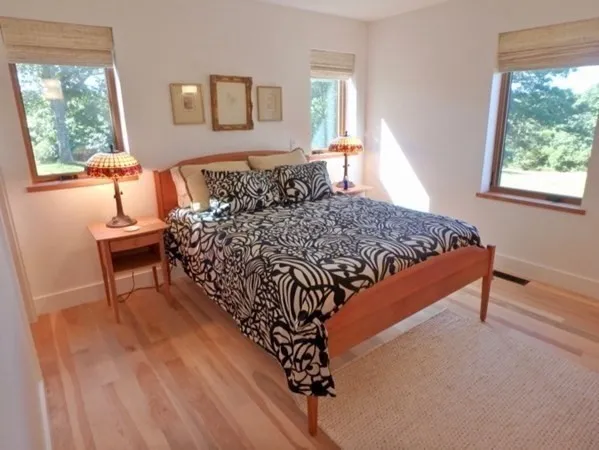 a bed sitting in a bedroom next to a window