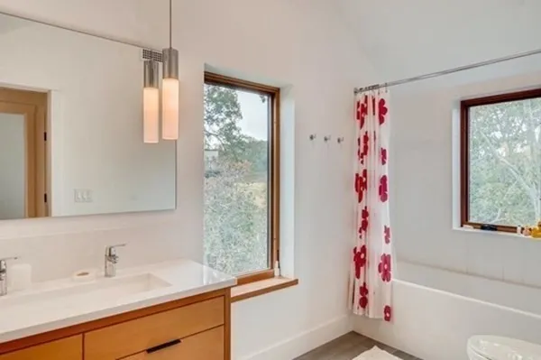 a bathroom with a sink a bath tub and a window