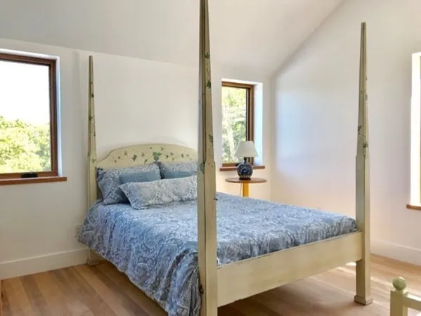 a bedroom with a large bed and a window