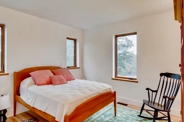 a bedroom with a bed and a window