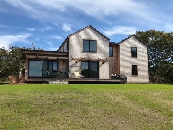a view of a house with a yard and sitting area