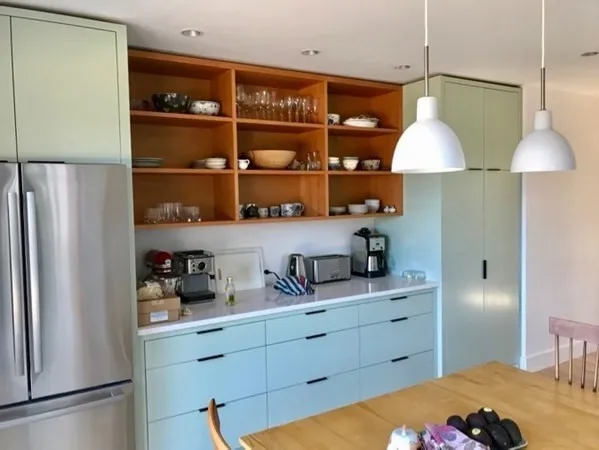 a kitchen with a refrigerator and a wooden floor