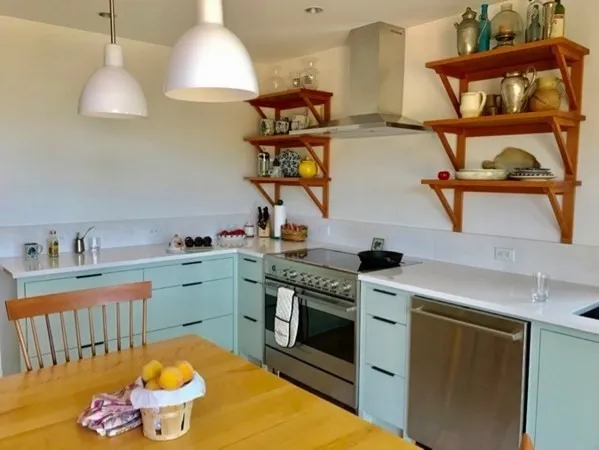 a kitchen with stainless steel appliances granite countertop a stove a sink and a wooden floors