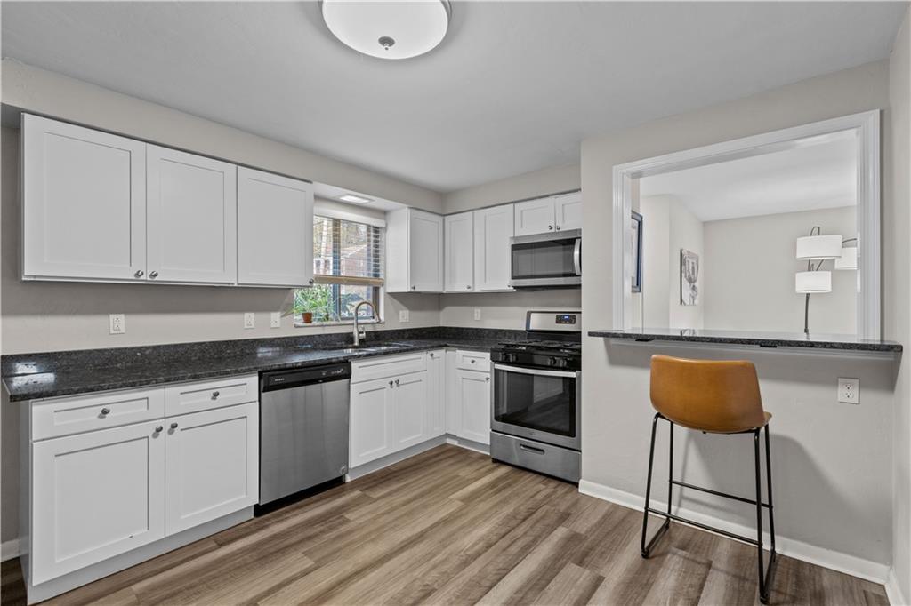 3407 Brighton Road Pittsburgh, PA 15212 - Photo 11 of 27 a kitchen with granite countertop white cabinets and white appliances