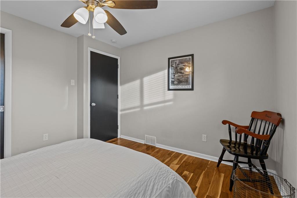 3407 Brighton Road Pittsburgh, PA 15212 - Photo 21 of 27 a bedroom with a bed and a chandelier