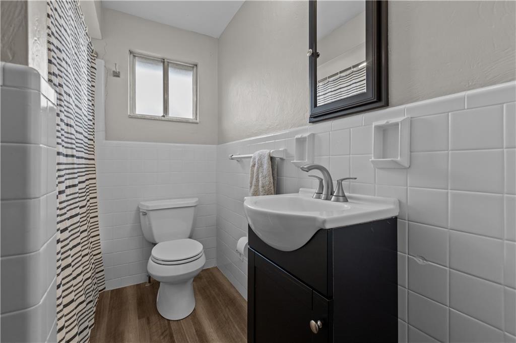 3407 Brighton Road Pittsburgh, PA 15212 - Photo 22 of 27 a bathroom with a toilet sink and mirror