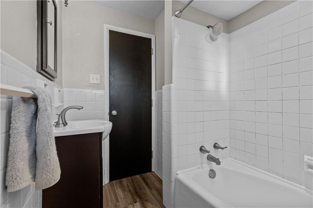 3407 Brighton Road Pittsburgh, PA 15212 - Photo 23 of 27 a bathroom with a bathtub sink and mirror
