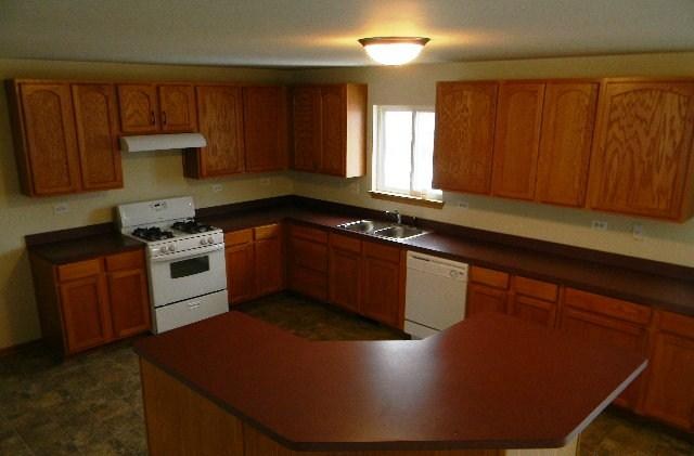 224 Ridgestone Trail Poplar Grove, IL 61065 - Photo 5 of 17 a kitchen with granite countertop a sink a stove and cabinets