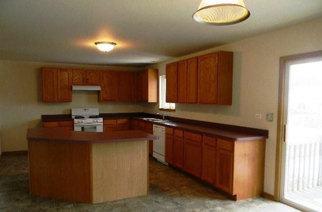 224 Ridgestone Trail Poplar Grove, IL 61065 - Photo 6 of 17 a kitchen with stainless steel appliances granite countertop a sink stove and cabinets
