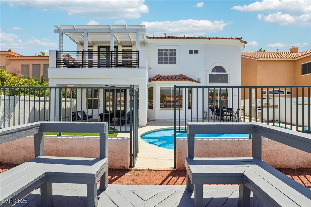 2469 Sun Reef Road Las Vegas, NV 89128 - Photo 78 of 93 Rear view of property with a balcony, a patio, stucco siding, and a tiled roof