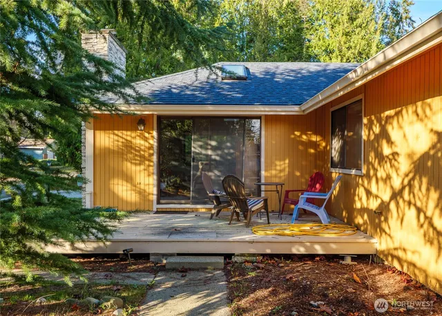 a bathroom with a granite countertop sink a mirror and shower
