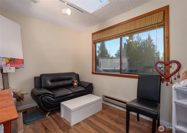 a front view of a house with a yard and trees