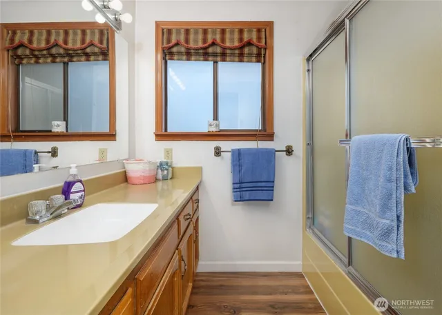 a green field with lots of trees in the background