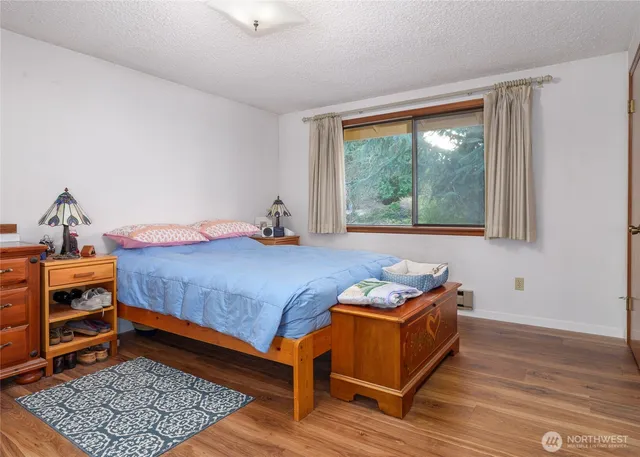 a view of a swimming pool with a yard and trees