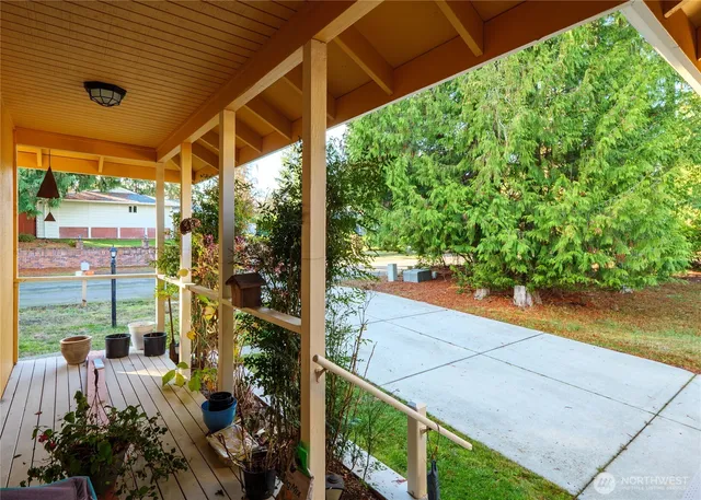 a living room with furniture a flat screen tv and a table