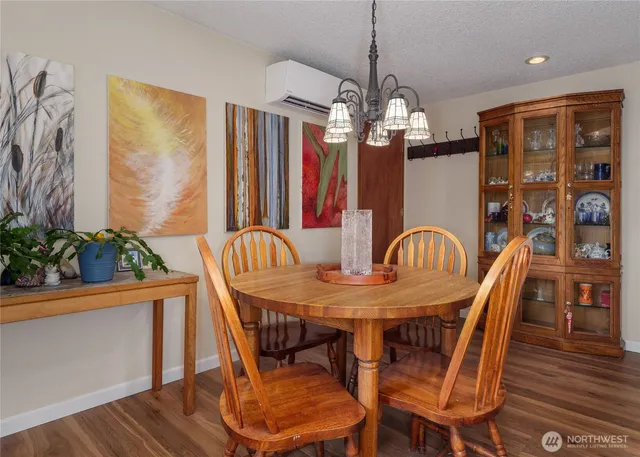 a living room with furniture a fireplace and a large window
