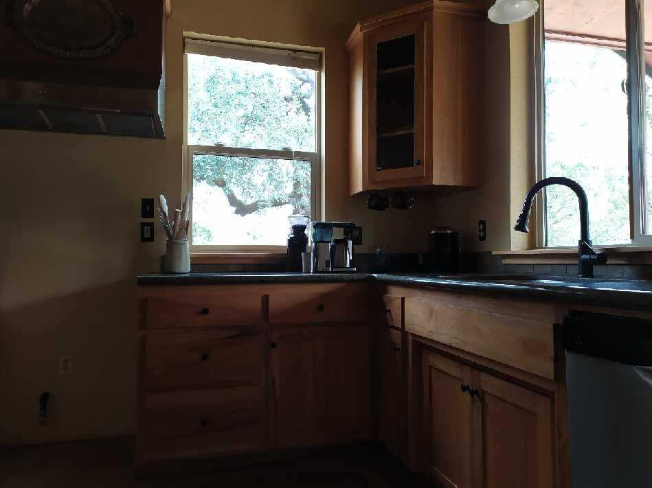 27203 Donkey Mine Road Oak Run, CA 96069 - Photo 13 of 22 a kitchen with a sink a window and cabinets
