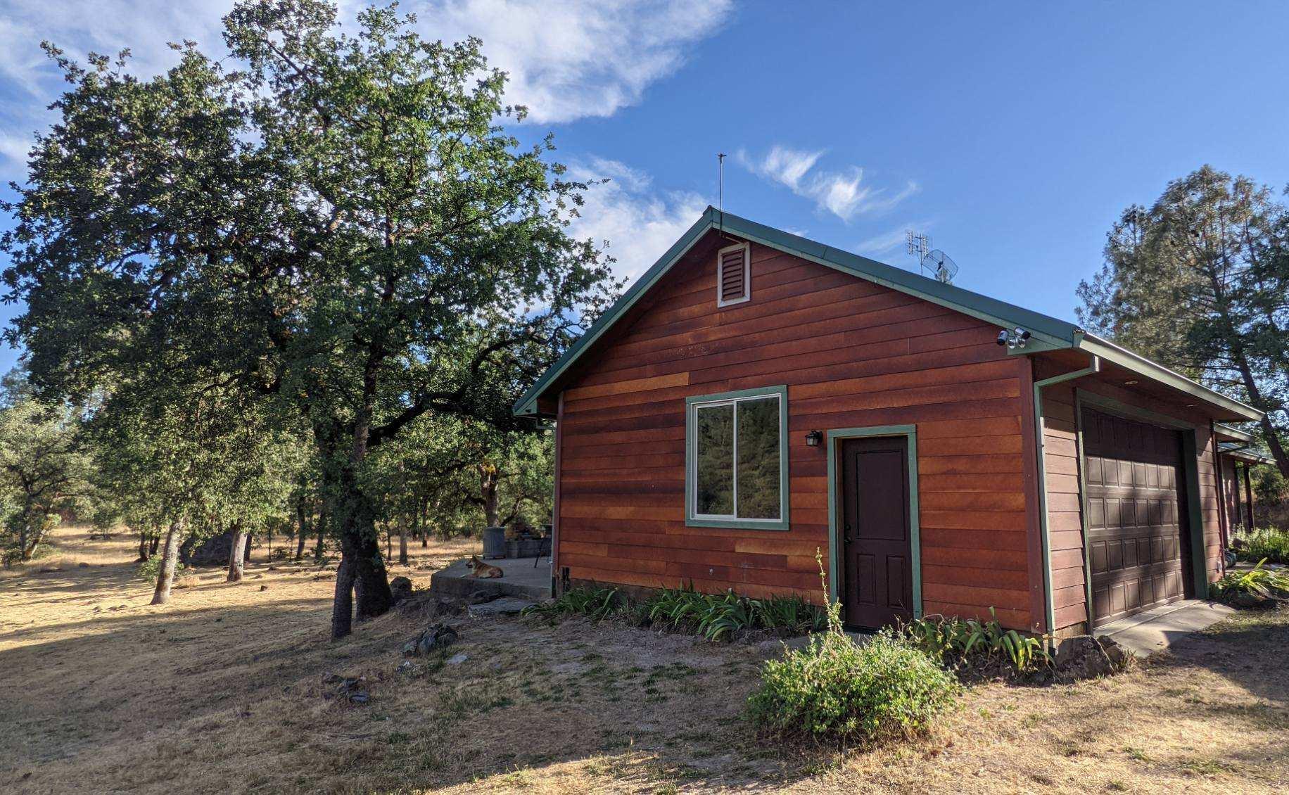 27203 Donkey Mine Road Oak Run, CA 96069 - Photo 19 of 22 a front view of a house with garden