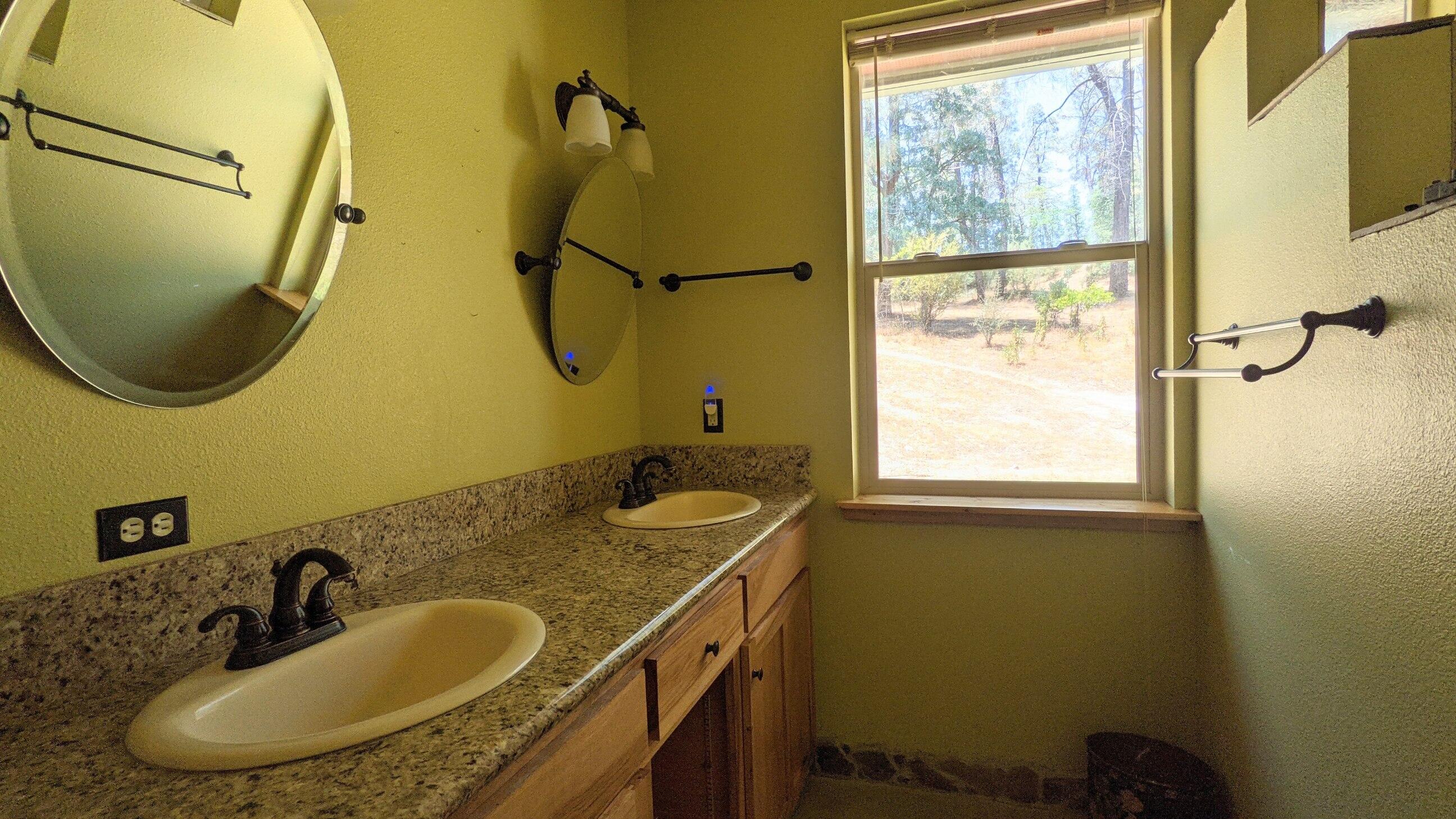 27203 Donkey Mine Road Oak Run, CA 96069 - Photo 7 of 22 a bathroom with a sink and mirror