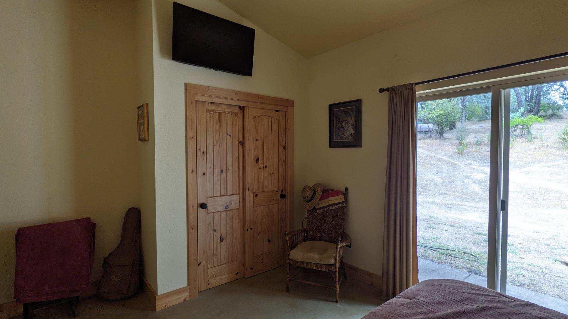 27203 Donkey Mine Road Oak Run, CA 96069 - Photo 9 of 22 a view of a hallway with a chair and a floor to ceiling window